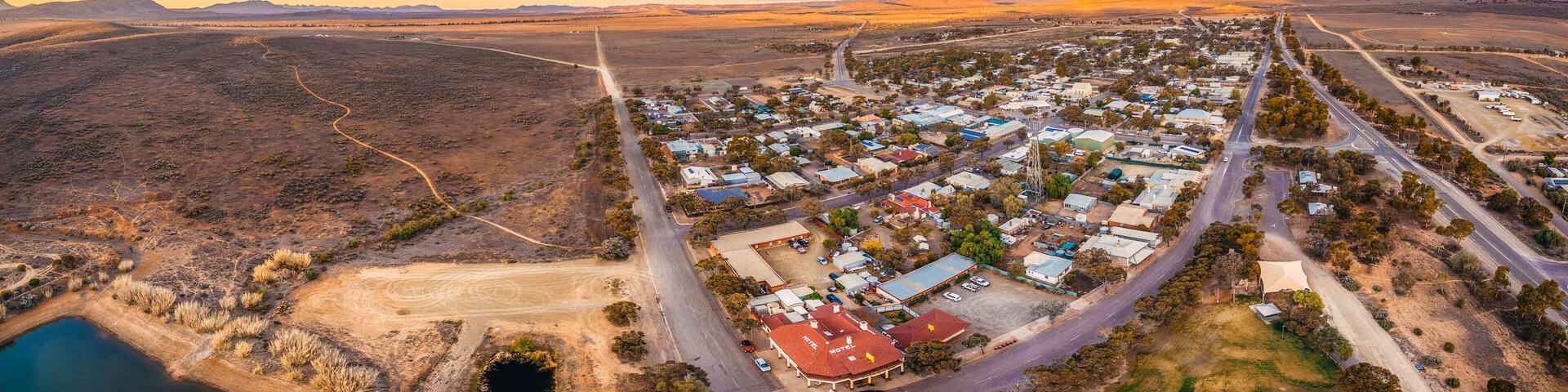Aerial panorama of rural road passing through Hawker - town in South Australia at sunset