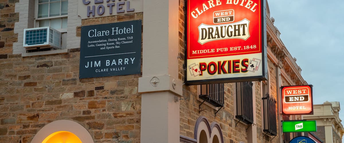 A building with signs for Clare Hotel, Clare Valley, and SA Lotteries.