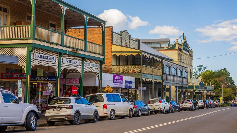 A street lined with vintage shops, including a hairdresser and a video store.