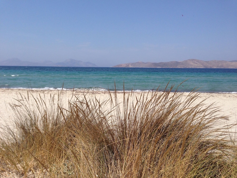 Sand , crystal blue water , sand dunes and salt lake nearby the beach . Tigaki, kos , Greece