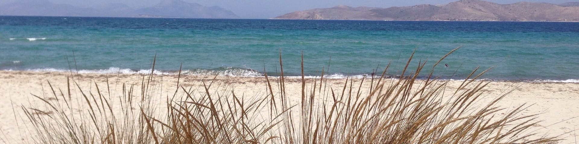Sand , crystal blue water , sand dunes and salt lake nearby the beach . Tigaki, kos , Greece