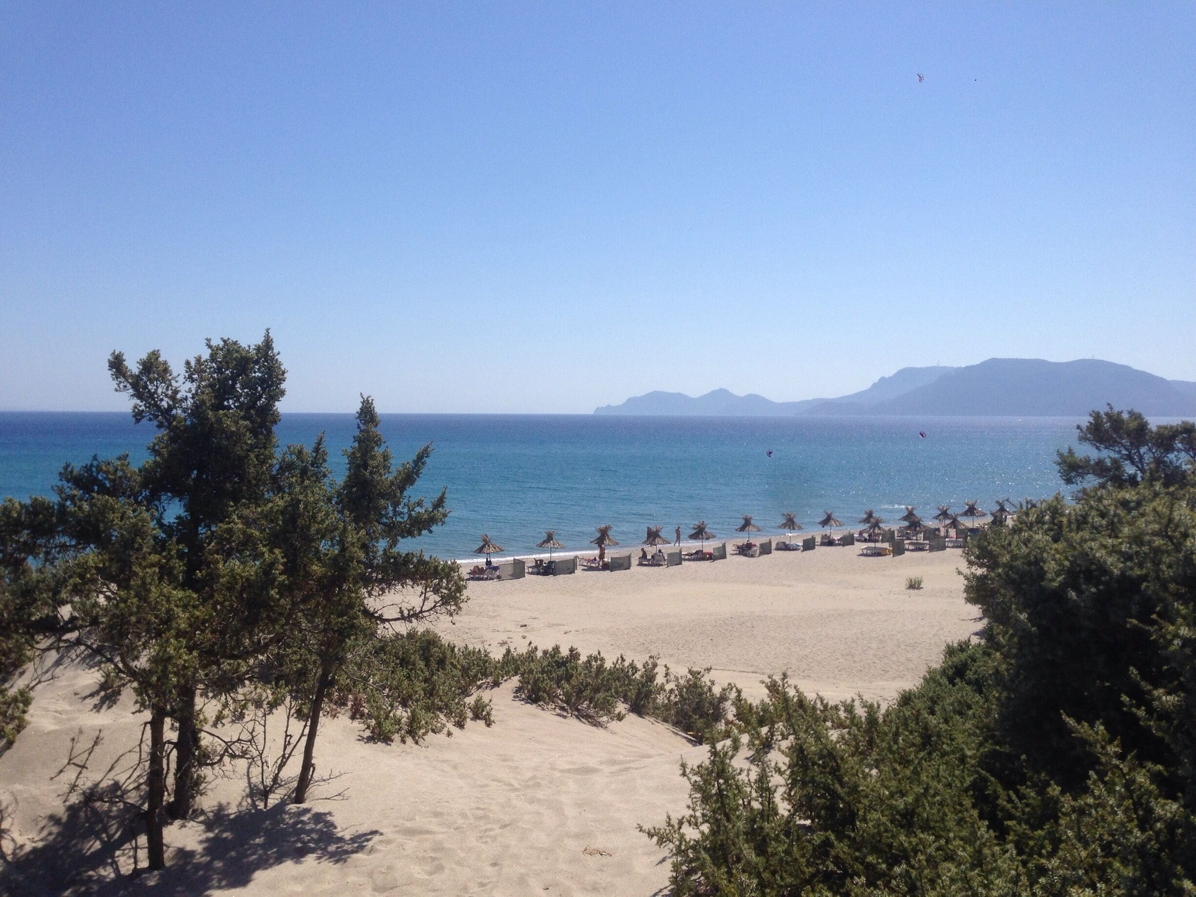 Exotic beach , paradise for nudists . Cedar trees , sand dunes , crystal clear water . Kos , Greece 