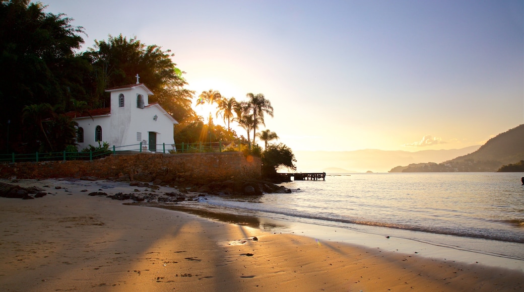 Gipoia Island featuring a church or cathedral, a sunset and a sandy beach