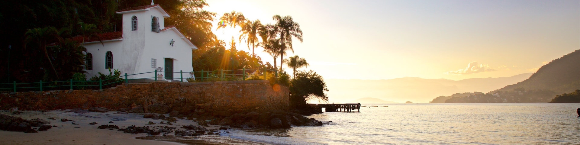 Gipoia Island which includes a beach, a sunset and a church or cathedral