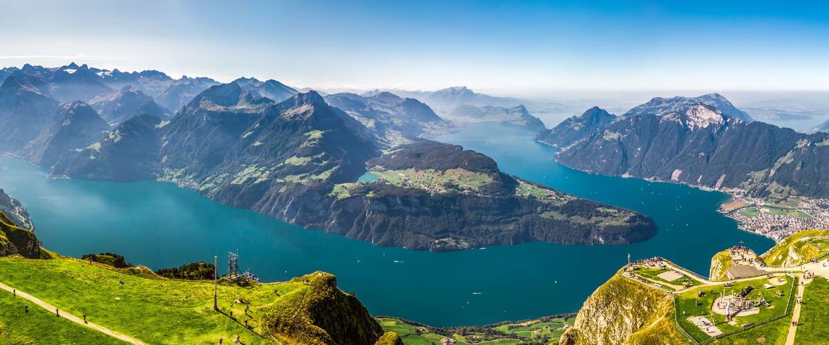 A mountainous landscape with a lake surrounded by rugged peaks.