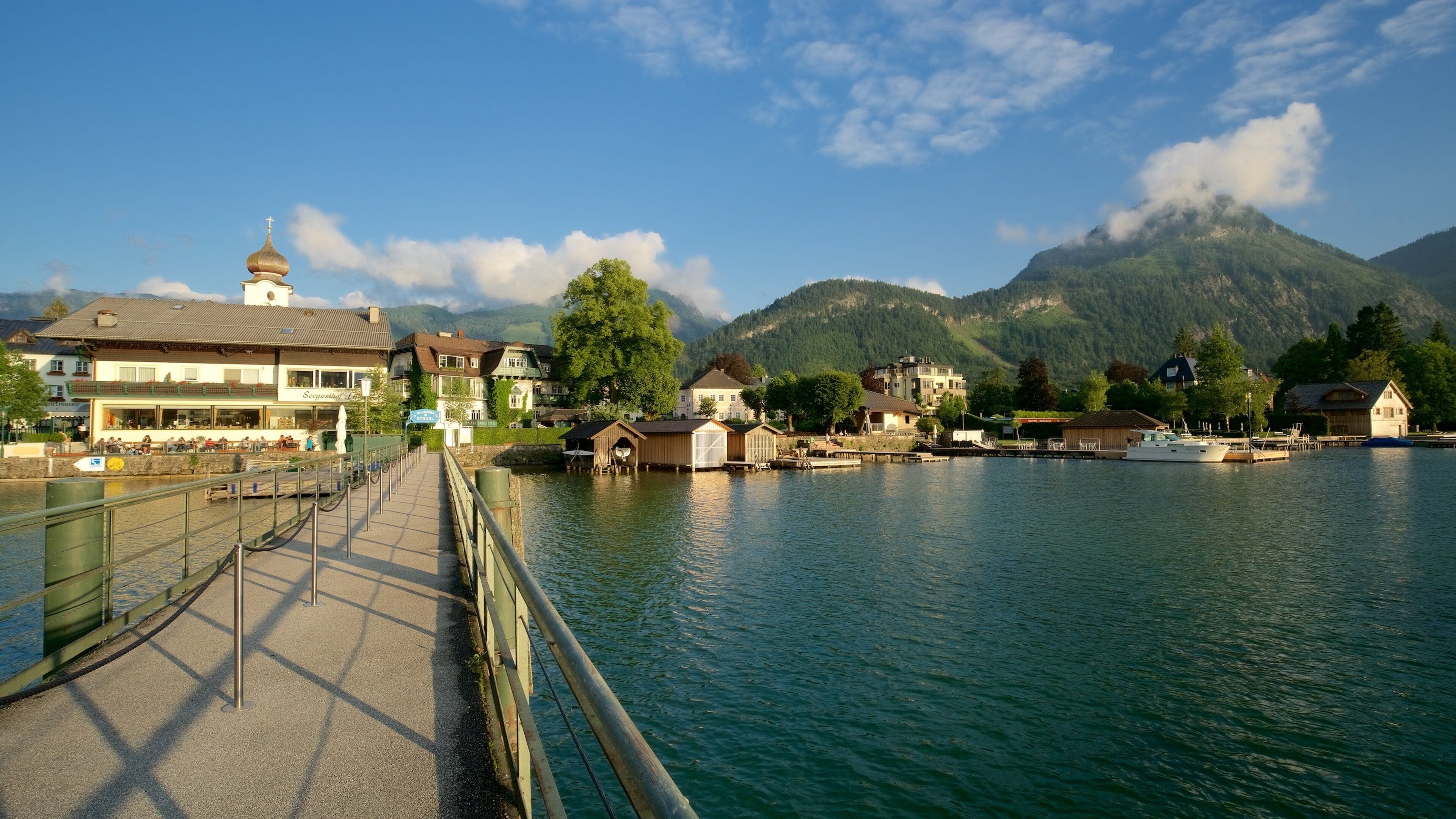 Strobl showing a sunset, a small town or village and a bridge