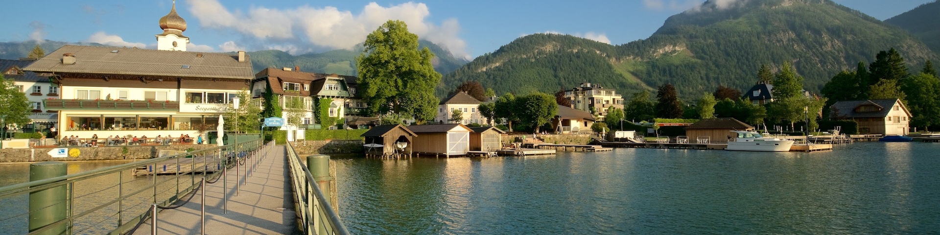Strobl showing a sunset, a small town or village and a bridge