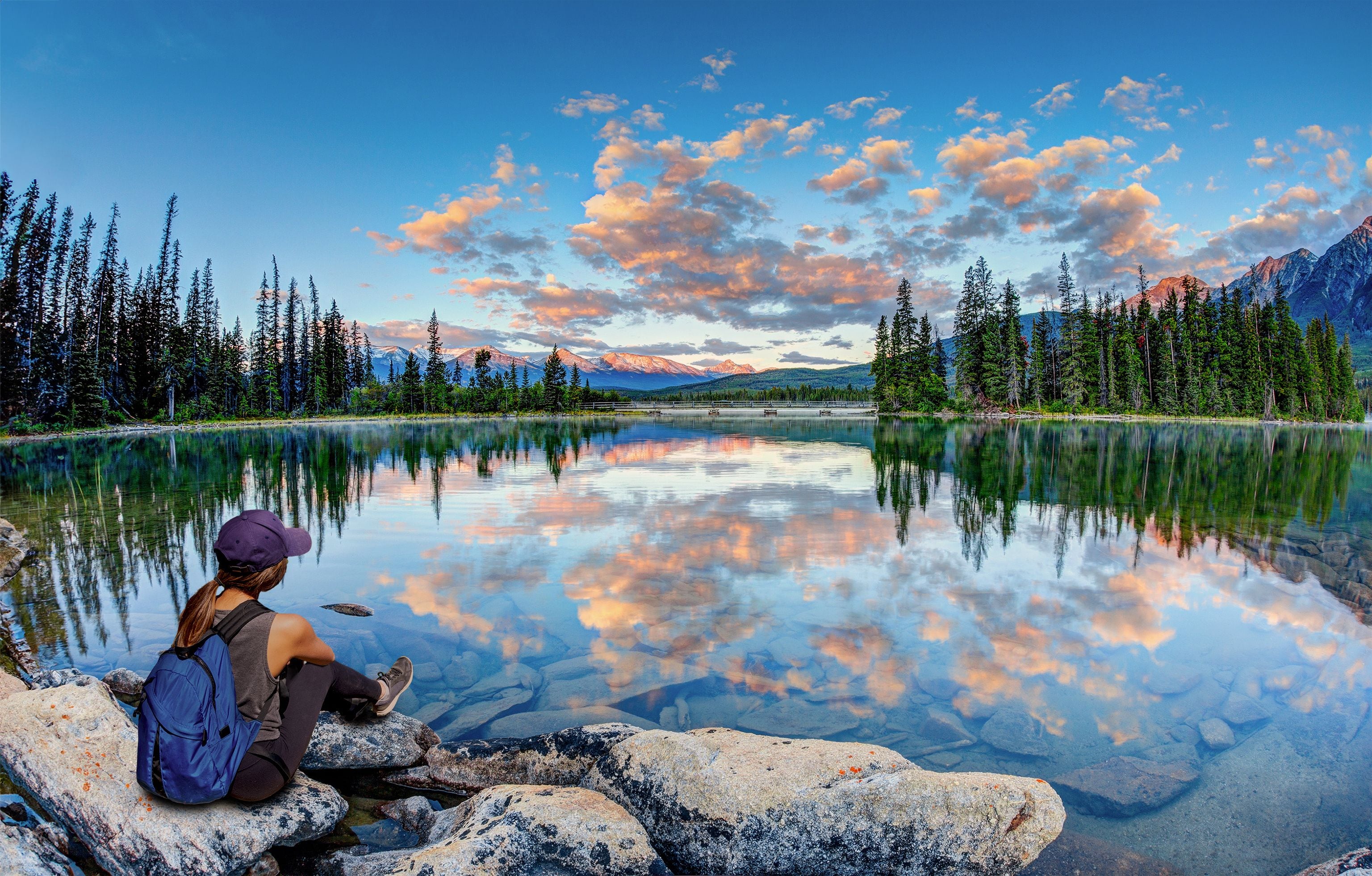 Girl hiker enjoying Summer sunrise at Pyramid Lake in Jasper National Park