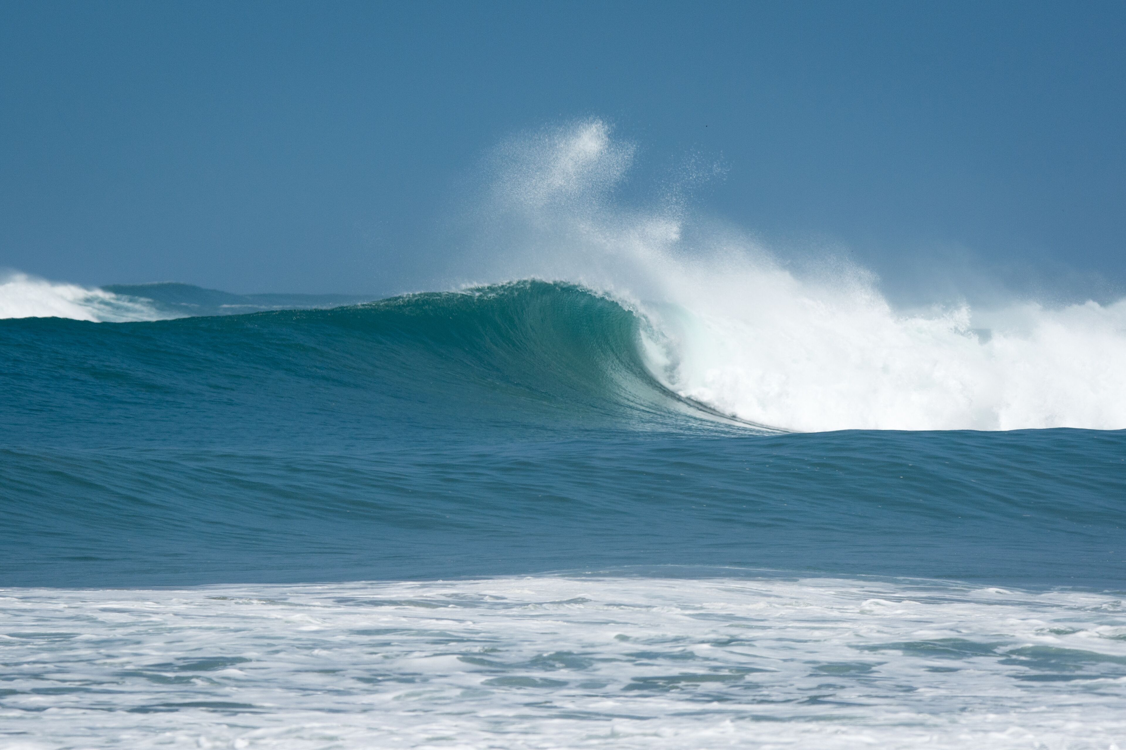 Ocean wave and spray against blue sky, Santa Cruz, Guanacaste, Costa Rica