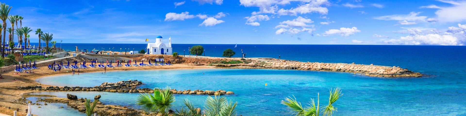 Panoramic View of Agios Nikolaos White Chapel and Louma Beach with turquoise sea in Protaras, Cyprus