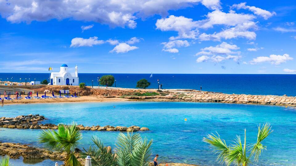 Panoramic View of Agios Nikolaos White Chapel and Louma Beach with turquoise sea in Protaras, Cyprus