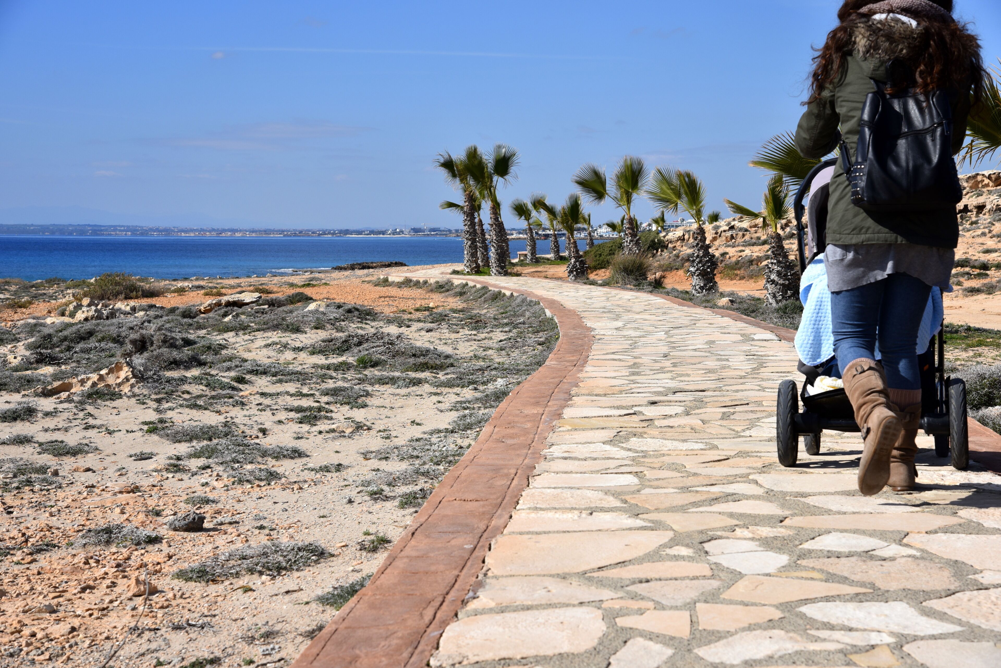 woman with stoller with baby going for a walk in ayia napa 