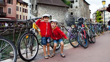 Portrait of two boys, brothers, in the town of Annecy, next to a channe