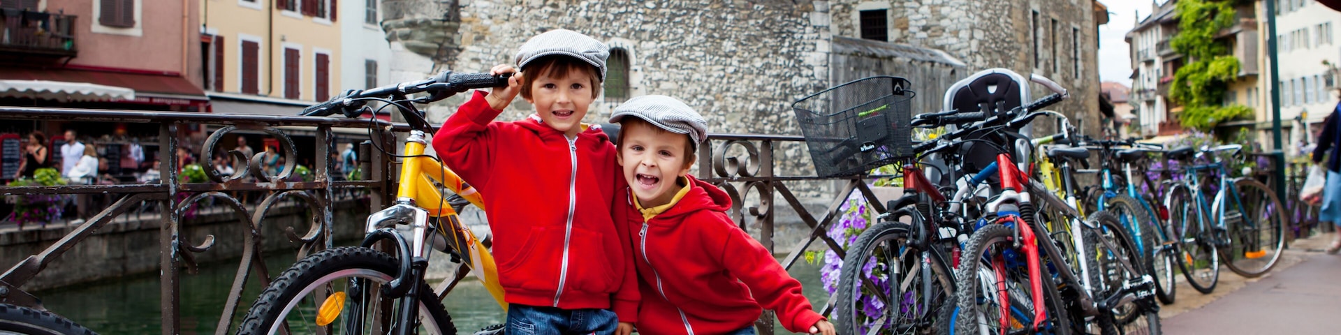 Portrait of two boys, brothers, in the town of Annecy, next to a channe