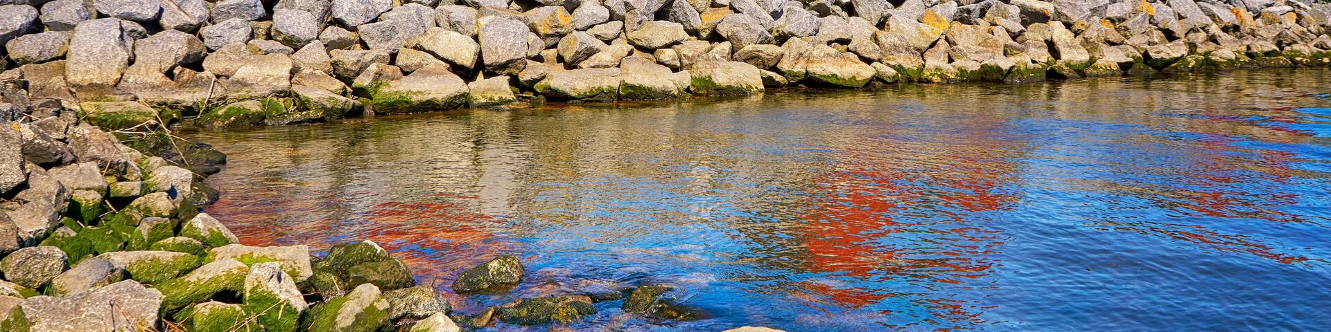 Breakwaters with red fisherman houses at the harbor Weiße Wiek in Boltenhagen at the Baltic Sea. Germany, Shutterstock ID 1240822249, Purchase Order: -