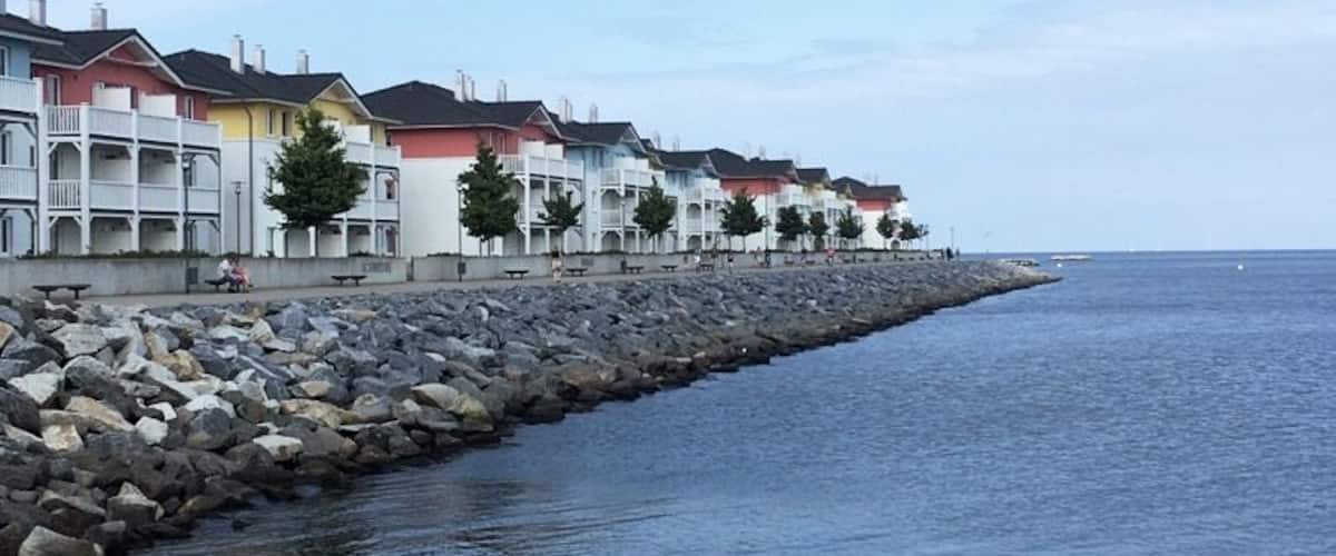 A coastal area with colorful houses along a rocky shoreline.