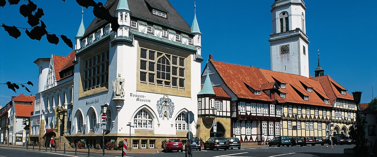 A historic building with a clock tower and a red-tiled roof.