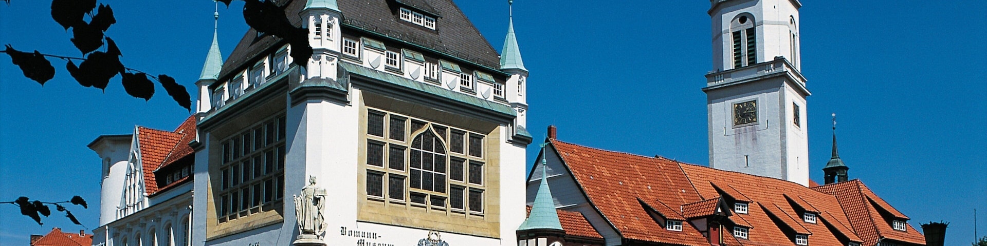 A historic building with a clock tower and a red-tiled roof.