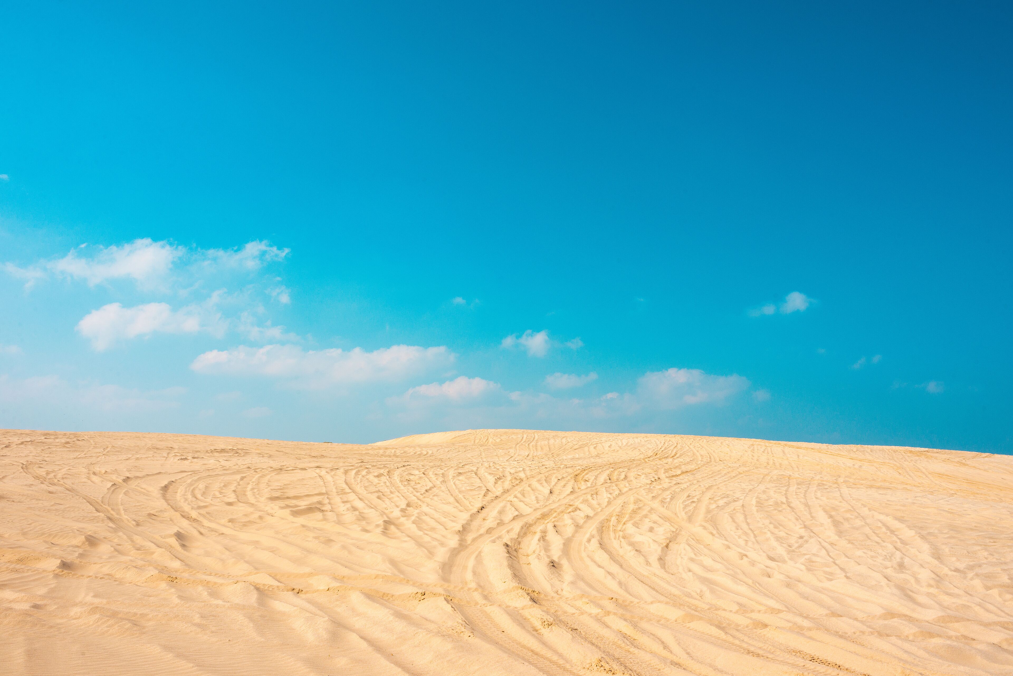 Golden dunes beach in madero city tamaulipas, sand mountain with vehicle marks and blue sky