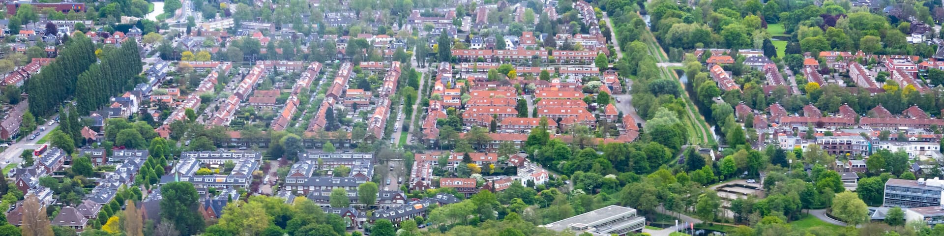 Aerial view of Amsterdam city outside Schiphol airport during flight landing
