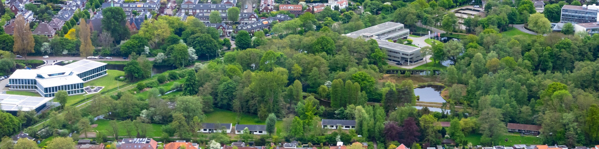 Aerial view of Amsterdam city outside Schiphol airport during flight landing