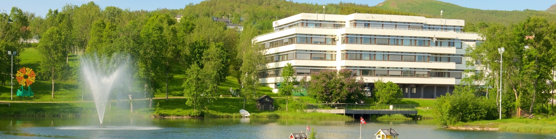 Finnsnes which includes a fountain, a luxury hotel or resort and a lake or waterhole
