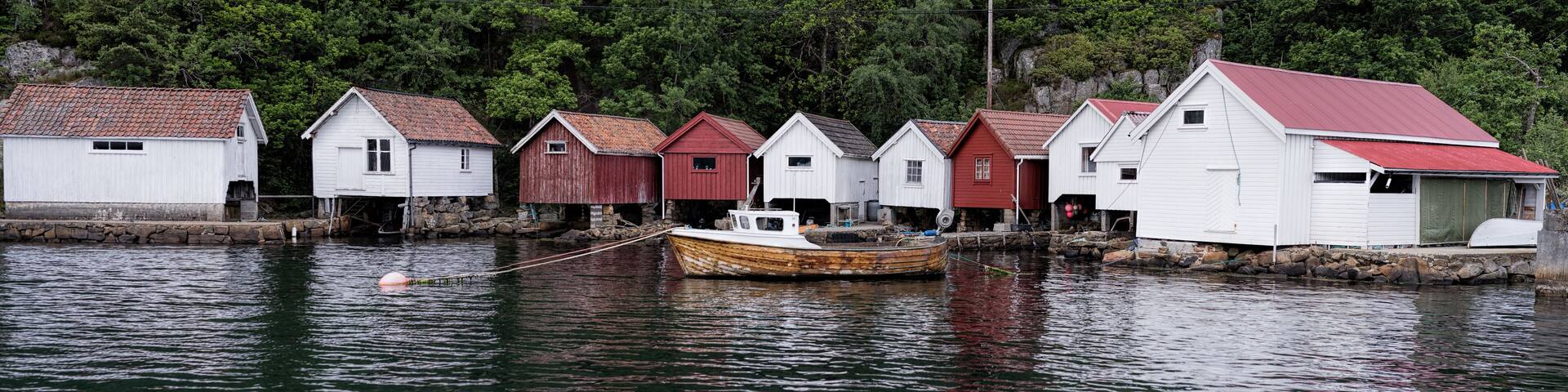 Norwegian boathouses.
These days many of these buildings have been converted to cabins, but these seems to for the boats.