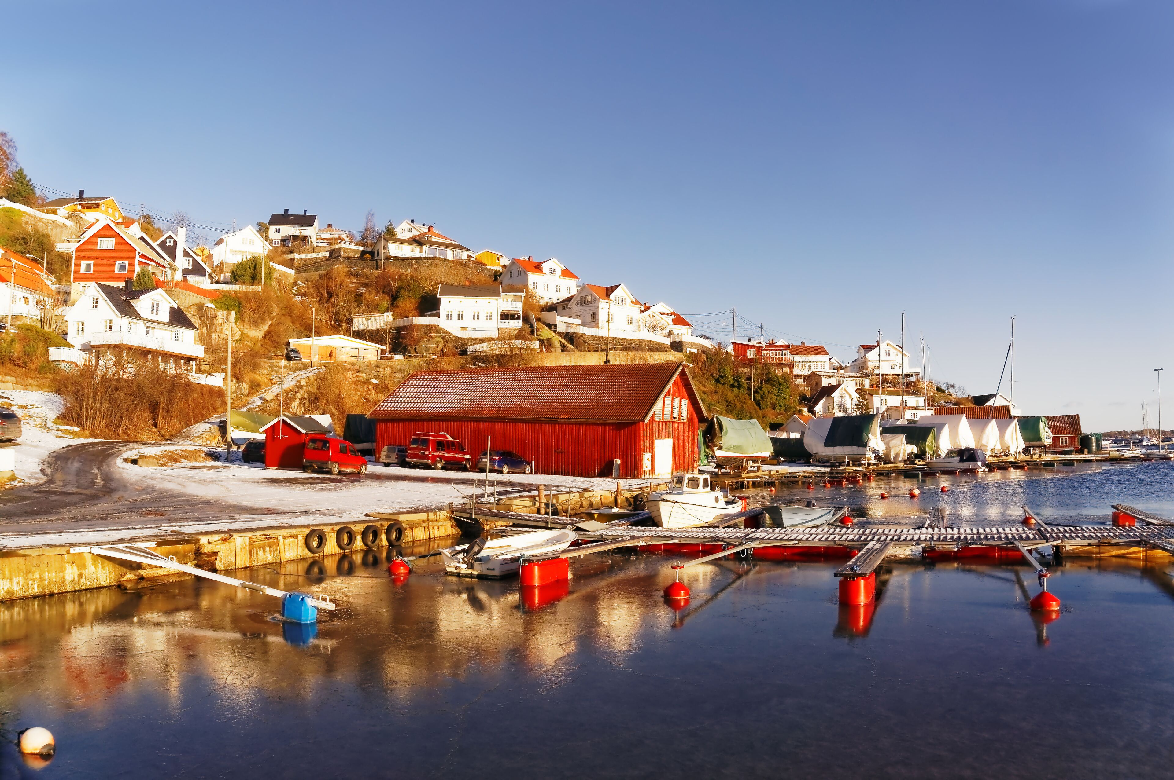 In winter, thin ice water. the Norwegian harbor for boats: Smedsbukta. Region of southeastern Norway. North Sea Coast. Skagerrak coastline. Norwegian landscape. Europe