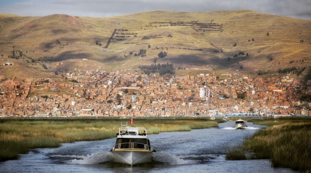 Boats going out to the islands made of reeds. The city of Puno is in the background #TroveOnTuesday