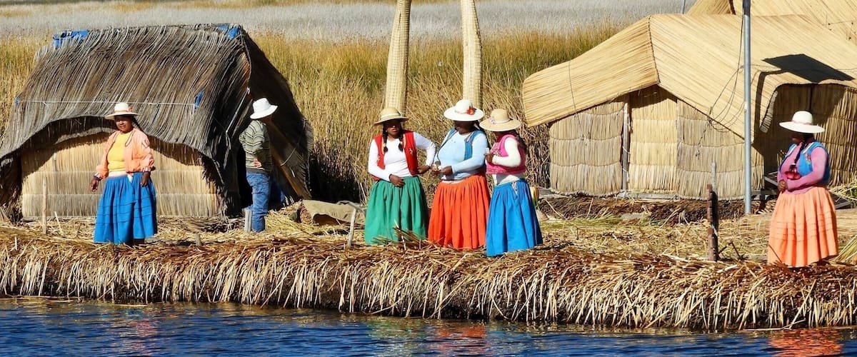 Locals waiting to welcome visitors into their village😊 man made islands made from reeds including their houses.