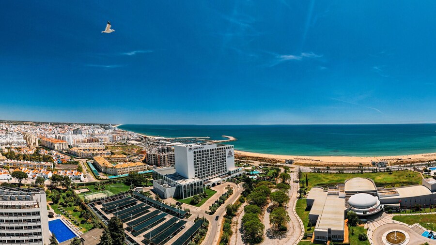 Aerial drone panoramic view of Vilamoura and Quarteira cities on the Algarve coast of southern Portugal on a sunny day