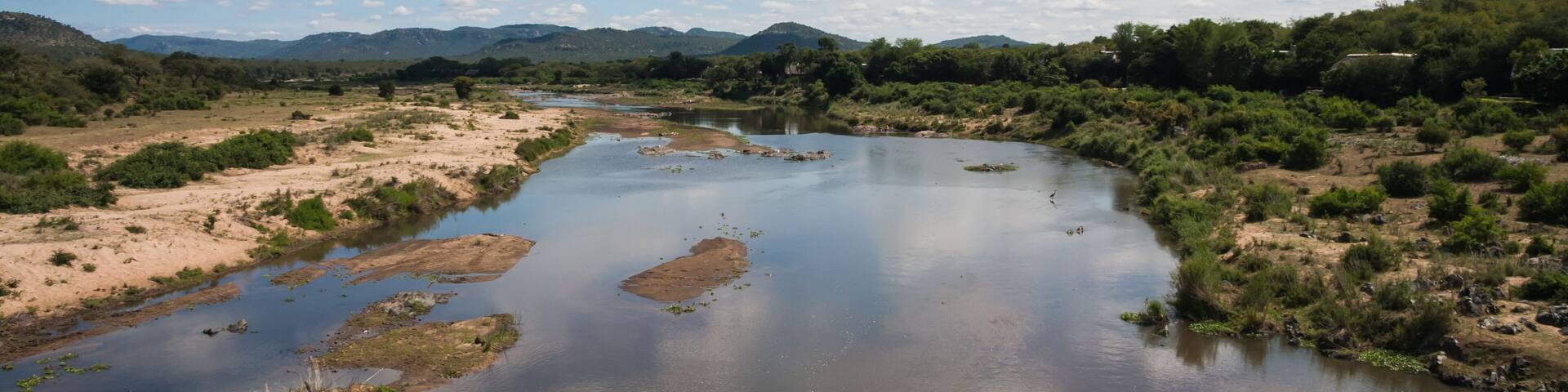 Scenic view from Malelane bridge at the entrance to Kruger National Park of the Crocodile river with cloud reflections