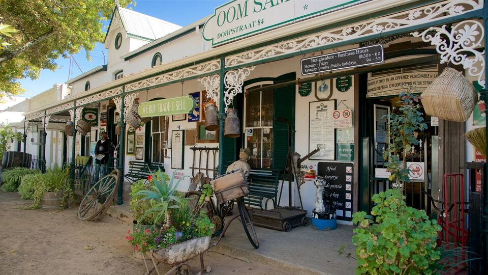 A traditional shop with a sign reading "We Buy Trade & Sell" and a vintage bicycle.