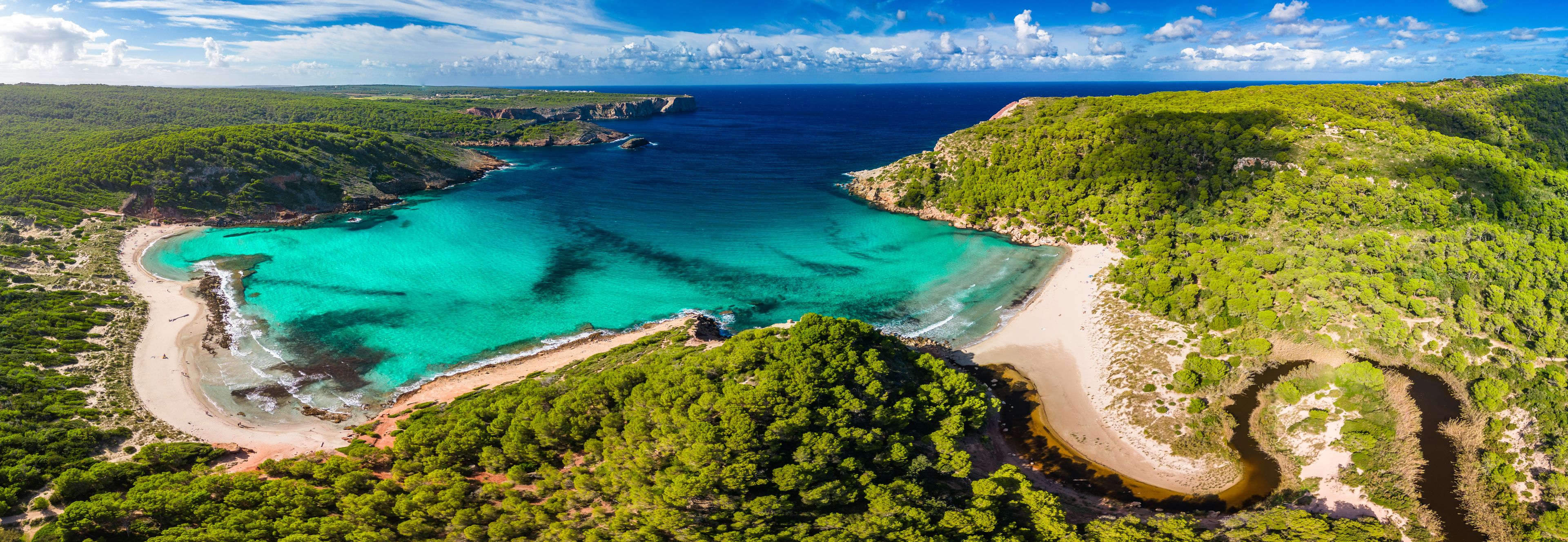 Aerial drone view of Menorca beach at cala de Algariens, Spain