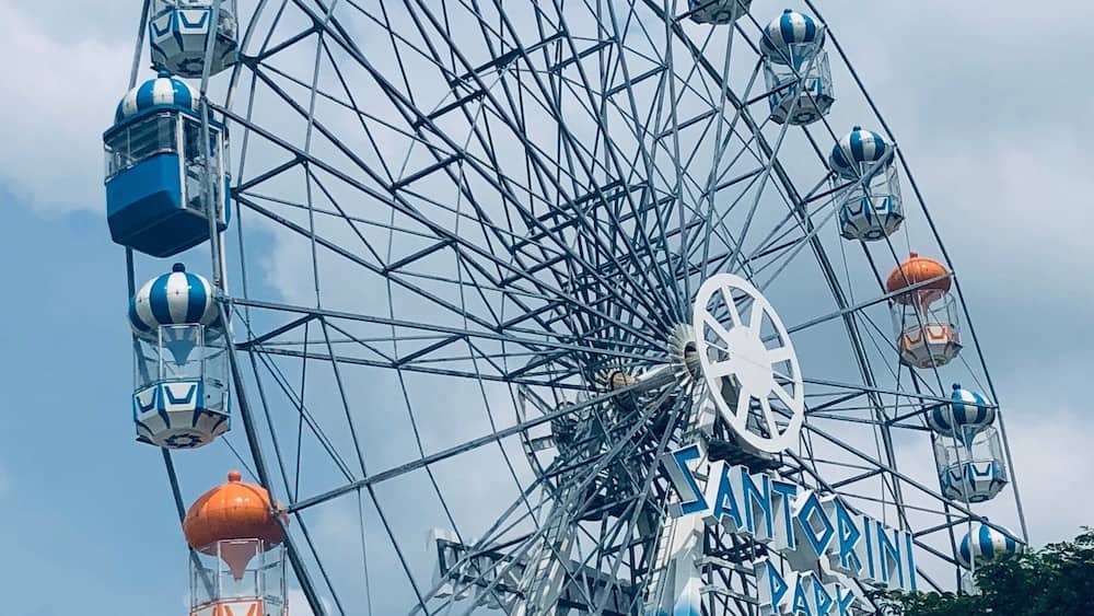 Santorini Park, Hua Hin, Thailand - a mini theme park with rides, and cute blue & white buildings housing shops and restaurants/eateries.