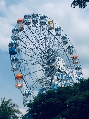 Santorini Park, Hua Hin, Thailand - a mini theme park with rides, and cute blue & white buildings housing shops and restaurants/eateries.