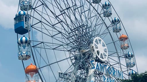 Santorini Park, Hua Hin, Thailand - a mini theme park with rides, and cute blue & white buildings housing shops and restaurants/eateries.