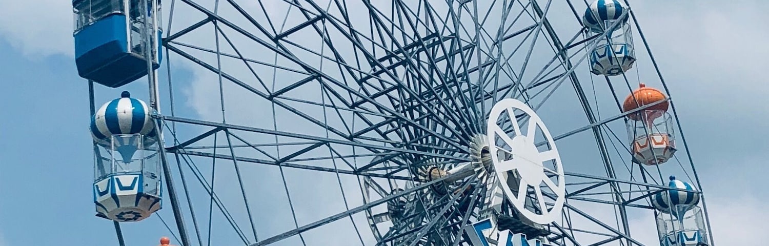 Santorini Park, Hua Hin, Thailand - a mini theme park with rides, and cute blue & white buildings housing shops and restaurants/eateries.