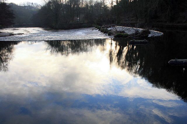 The calm before the weir The Derwent flows over the first of three weirs near Milford. It is this one which would have provided the head of water for the Mill a few hundred yards or so downstream. Both ends of the weir have the remains of sluice mechanisms. The majority of the abstraction would have taken place on the far side and water still flows through the race there as can be seen as it rejoins the river downstream of the next two weirs just south of the bridge (in SK3545).