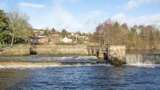 Water flowing under a stone arched bridge
