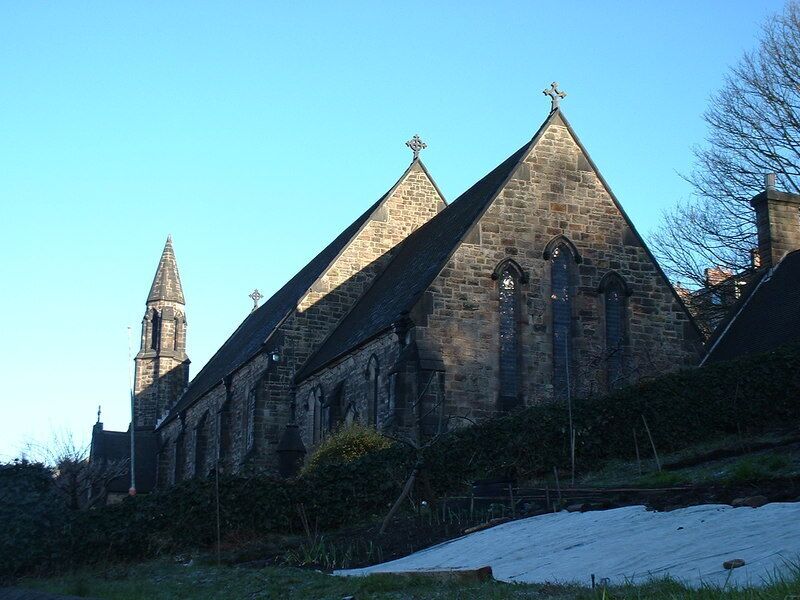 A historic church with a prominent tower and pointed roof.