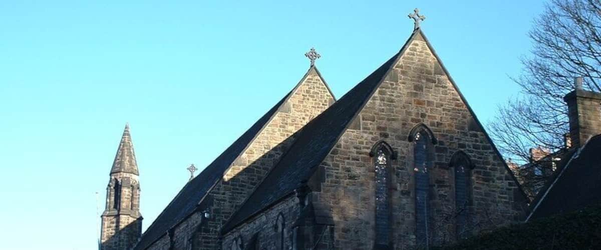 A historic church with a prominent tower and pointed roof.