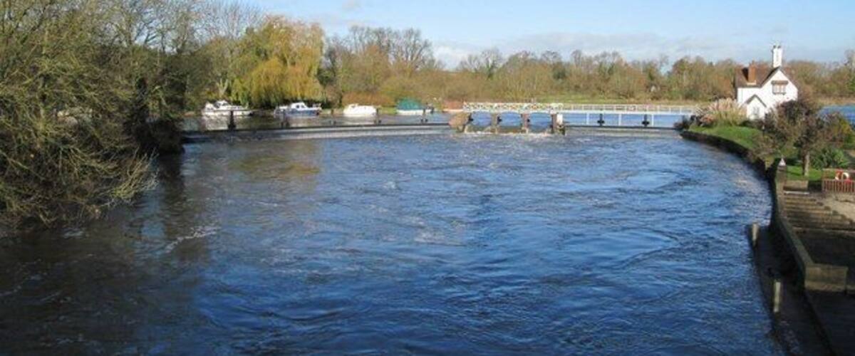 Goring Weir in flow The Thames is quite high so the sluices are open to stop flooding further upstream. Goring lock can just be seen on the right. To the left of the weir there used to be a pillbox on the island but this was demolished when the weir was improved.