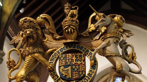 Royal Arms (of King James I or Queen Anne) in St Michael's Church, Bray, Berkshire, England. The supporters (lion and unicorn) are fully sculpted with the shield and Garter belt repeated on the rear.
