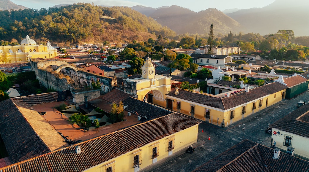 Aerial view of Santa Catalina Arch with colonial buildings and terracotta rooftops in the golden light of Antigua Guatemala, Sacatepequez Department, Guatemala.