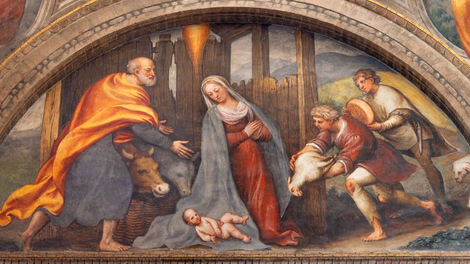 A fresco with a religious scene, including figures, a baby, and animals.