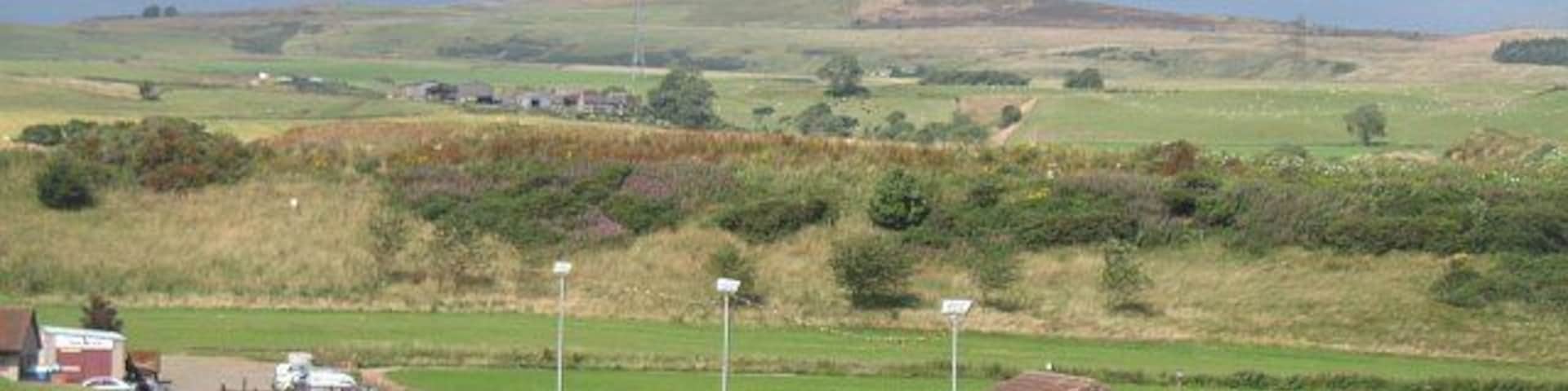 Car park and pavilion, Hawk Hill Park in Leslie with Falkland Hill on the skyline.
