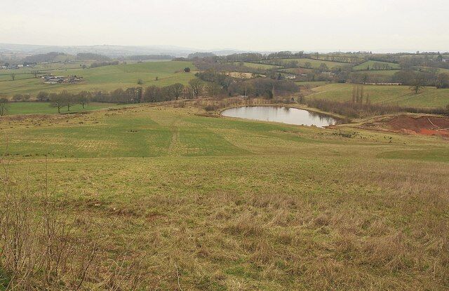 Pond, Town Farm Quarry The pond is at the northern corner of the Town Farm Quarry site, east of Burlescombe. The Eastbrook valley beyond is in ST0717 / ST0817. View from the C102.