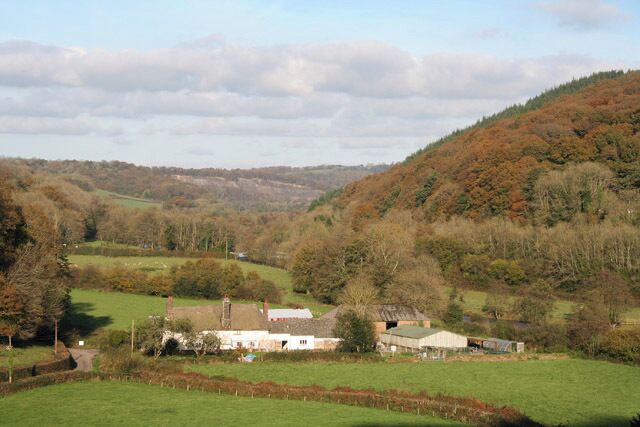 Washfield: the Exe valley and Hatherland Mill. Seen from Hatherland Wood, looking north. In the distance can be seen the disused Holmingham Quarry. The mill is listed by the DOE as a Grade II former farmhouse and there is no mention of its earlier function. However a local resident remembers his grandfather dressing the mill stones and a chipping extinguishing the candle!