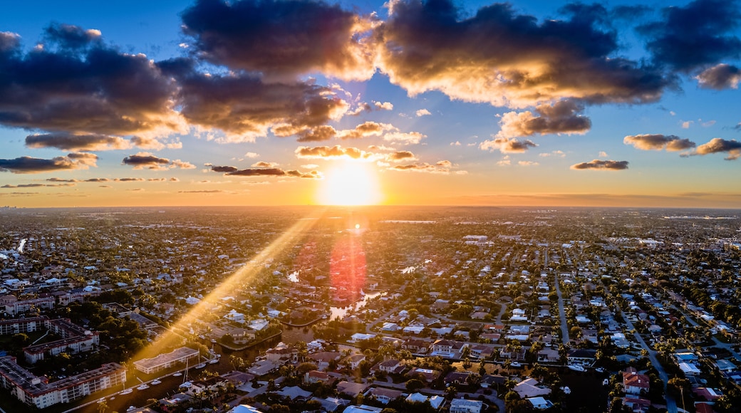 drone shot of sunset with clouds over city in Florida